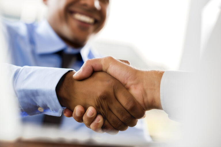 Close-up of two businessmen shaking hands.